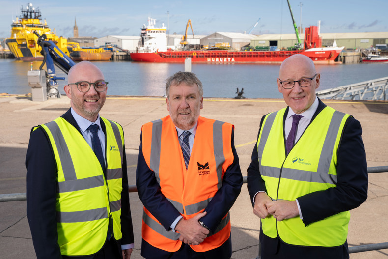 Stuart Hood, Director of Offshore Wind Operations at SSE Renewables, Tom Hutchison, CEO of Montrose Port Authority, and First Minister John Swinney standing at Montrose Port