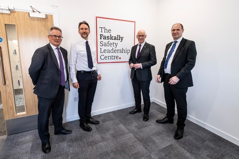 The First Minister of Scotland with SSE's CEO designate, Head of SHE and Chairman of SSEN Transmission board standing in suits in front of the Faskally Centre's sign